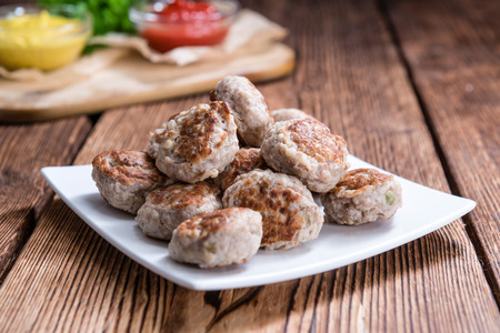 Homemade Meatballs (selective focus) on dark wooden backgroundの写真素材