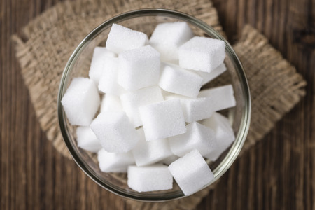 Portion of white Sugar (selective focus) in a bowl (on vintage wooden background)の写真素材
