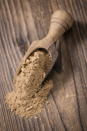 Galangal Powder(detailed close-up shot) on an old wooden tableの写真素材