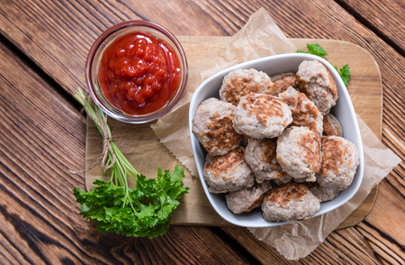 Homemade Meatballs (selective focus) on dark wooden backgroundの写真素材