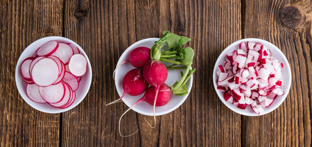 Radishes (whole, sliced and diced) as detailed close-up shot (selective focus)の写真素材