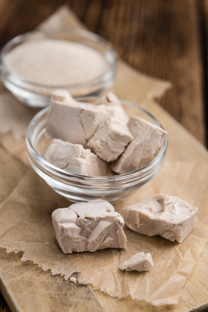 Portion of Yeast (fresh and dried)on vintage wooden background (close-up shot)の写真素材