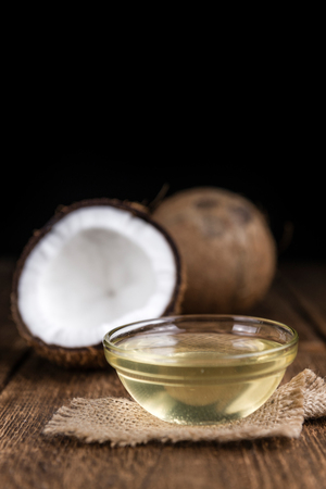 Coconut Oil (selective focus) on an old wooden table (close-up shot)の写真素材