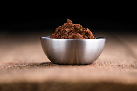 Cocoa powder (selective focus) as detailed close-up shot on wooden backgroundの写真素材