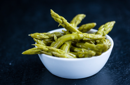 Preserved green Asparagus (selective focus) on a slate slabの写真素材