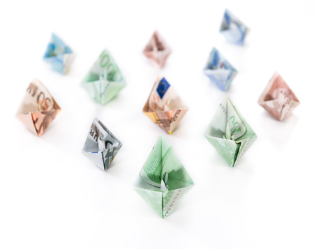 Fleet of boats made out of European banknotes on white background (close-up shot)の写真素材