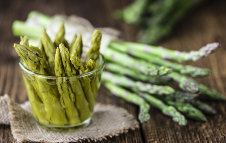 Preserved green Asparagus (selective focus) on wooden backgroundの写真素材