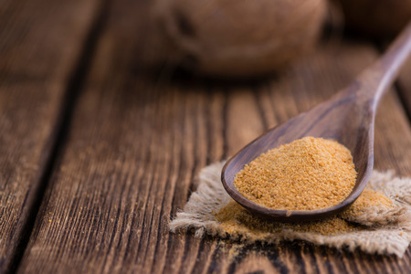 Portion of golden Coconut Sugar (selective focus) on vintage wooden backgroundの写真素材