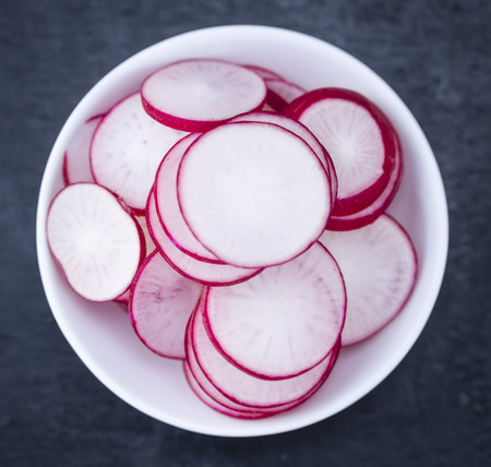 Sliced Radishes on a slate slab (detailed close-up shot; selective focus)の写真素材