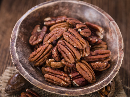 Pecan Nuts (selective focus) on an old vintage wooden tableの写真素材