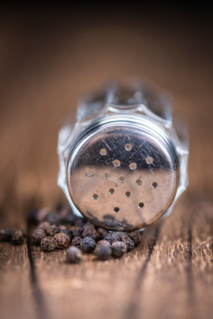 Pepper Shaker on wooden background (selective focus; close-up shot)の写真素材