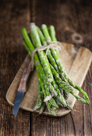 Portion of green Asparagus (close-up shot) on wooden backgroundの写真素材