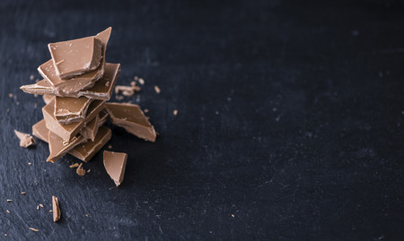 Milk Chocolate (selective focus) on a slate slab (close-up shot)の写真素材