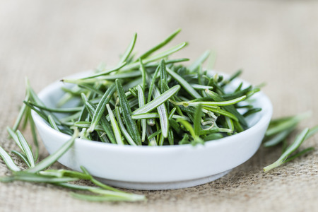 Fresh Rosemary (selective focus; close-up shot) on wooden backgroundの写真素材