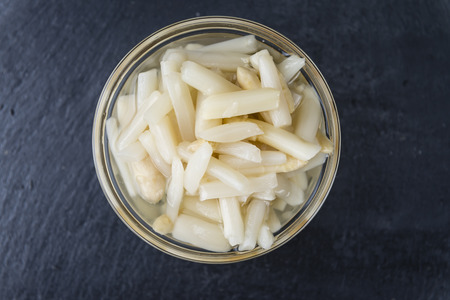 Preserved white Asparagus on a slate slab (selective focus; close-up shot)の写真素材