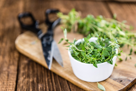 Fresh Thyme (close-up shot) on wooden background (selective focus)の写真素材
