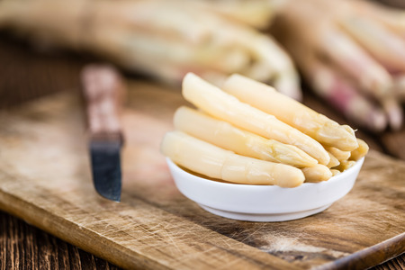 White Asparagus (preserved; close-up shot; selective focus) on wooden backgroundの写真素材