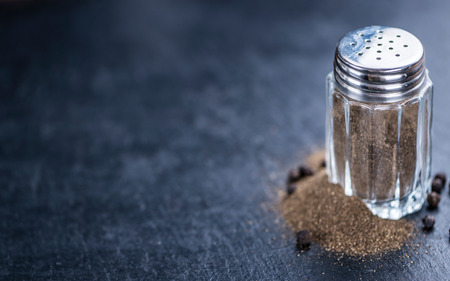 Pepper Shaker (selective focus; close-up shot) on a slate slabの写真素材