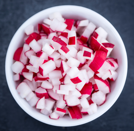 Diced Radishes (close-up shot) on a slate slab (selective focus)の写真素材