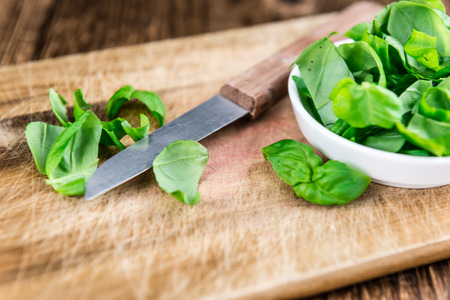 Fresh Basil (close-up shot; selective focus) on an old rustic wooden tableの写真素材