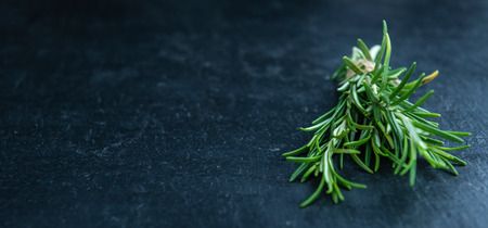 Fresh Rosemary (selective focus; close-up shot) on a slate slabの写真素材