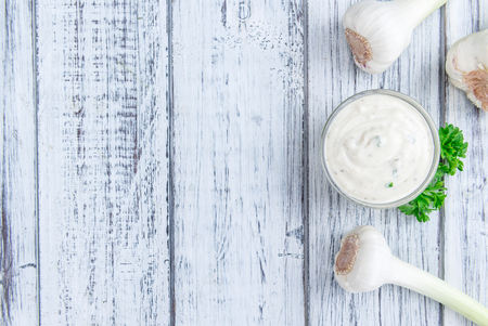 Fresh made Garlic Sauce (selective focus) on wooden background (detailed close-up shot)の写真素材