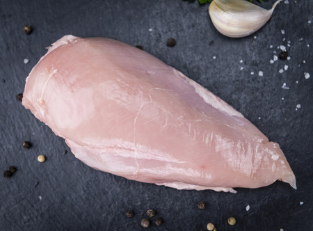 Slate slab with fresh Chicken Meat (close-up shot) on a slate slabの写真素材