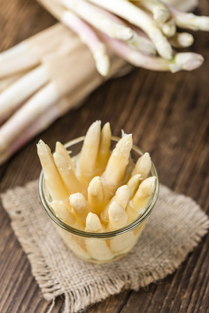 Portion of white Asparagus (close-up shot; selective focus) on wooden backgroundの写真素材