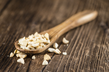 Heap of chopped Peanuts (selective focus) on vintage wooden backgroundの写真素材