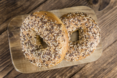 Fresh baked wholemeal Bagels (selective focus; close-up shot) with different seedsの写真素材