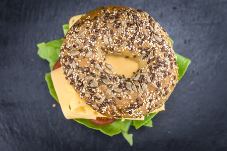 Cheese Bagel on a slate slab (selective focus; close-up shot)の写真素材