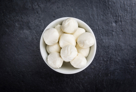 Mozzarella on a slate slab (selective focus; close-up shot)
