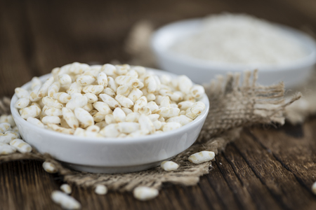Portion of puffed Rice (detailed close-up shot) on wooden backgroundの写真素材
