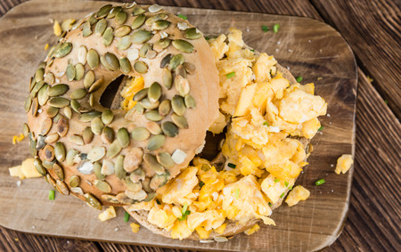 Breakfast Bagel with fried Eggs (selective focus) on vintage backgroundの写真素材