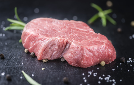 Piece of raw Beef Fillet on a slate slab (selective focus; close-up shot)の写真素材
