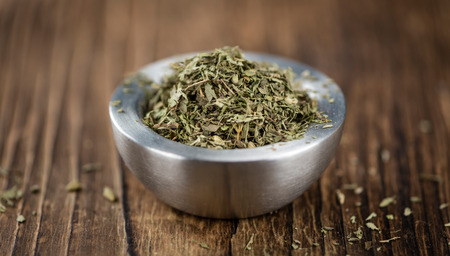 Old wooden table with dried Stevia leaves (close-up shot; selective focus)の写真素材