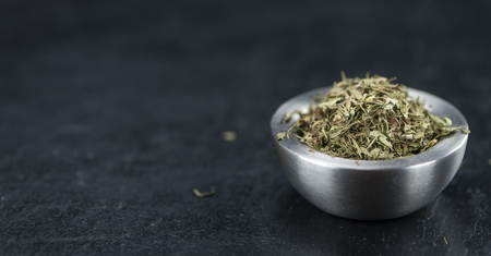 Heap of dried Stevia leaves (sweetener) on vintage background (close-up shot)の写真素材