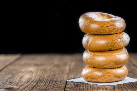 Fresh made plain Bagel (selective focus) on vintage background (close-up shot)の写真素材