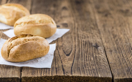 Fresh baked Rolls (selective focus) on an old wooden table