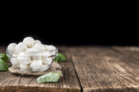 Old wooden table with small Mozzarella balls (selective focus)の写真素材