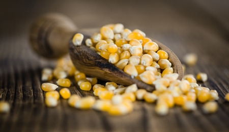 Dried Corn (detailed close-up shot; selective focus) on vintage wooden background