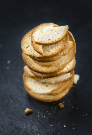 Portion of crunchy bread chips (selective focus; close-up shot) on vintage backgroundの写真素材