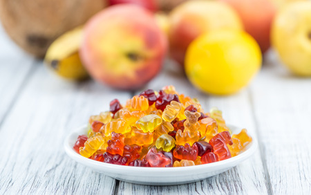 Wooden table with Gummy Bears (close-up shot; selective focus)の写真素材