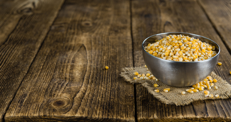 Dried Corn (detailed close-up shot; selective focus) on vintage wooden backgroundの写真素材