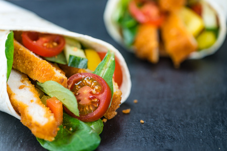 Chicken Wraps (selective focus) on a slate slab (close-up shot)の写真素材