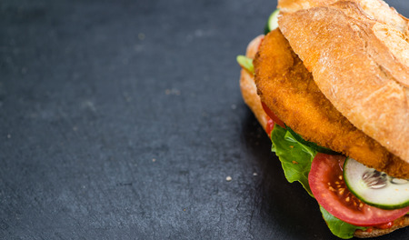 Slate slab with a Chicken Schnitzel (close-up shot; selective focus)の写真素材