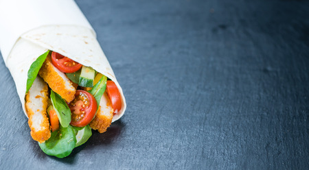 Chicken Wraps (selective focus) on a slate slab (close-up shot)の写真素材