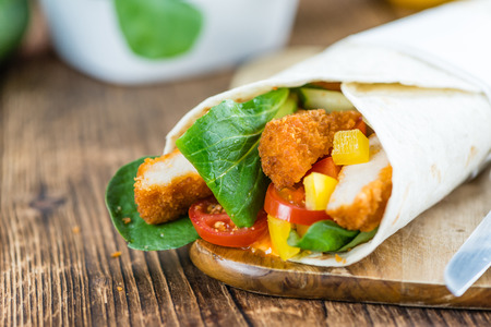 Fresh made Chicken Wraps on an vintage background (selective focus)の写真素材