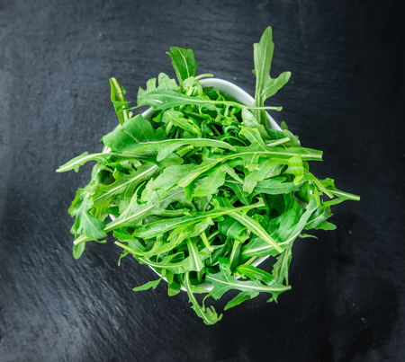 Portion of fresh Arugula (detailed close-up shot; selective focus)の写真素材