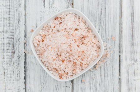 Himalayan Salt as high detailed close-up shot on a vintage wooden table (selective focus)の写真素材